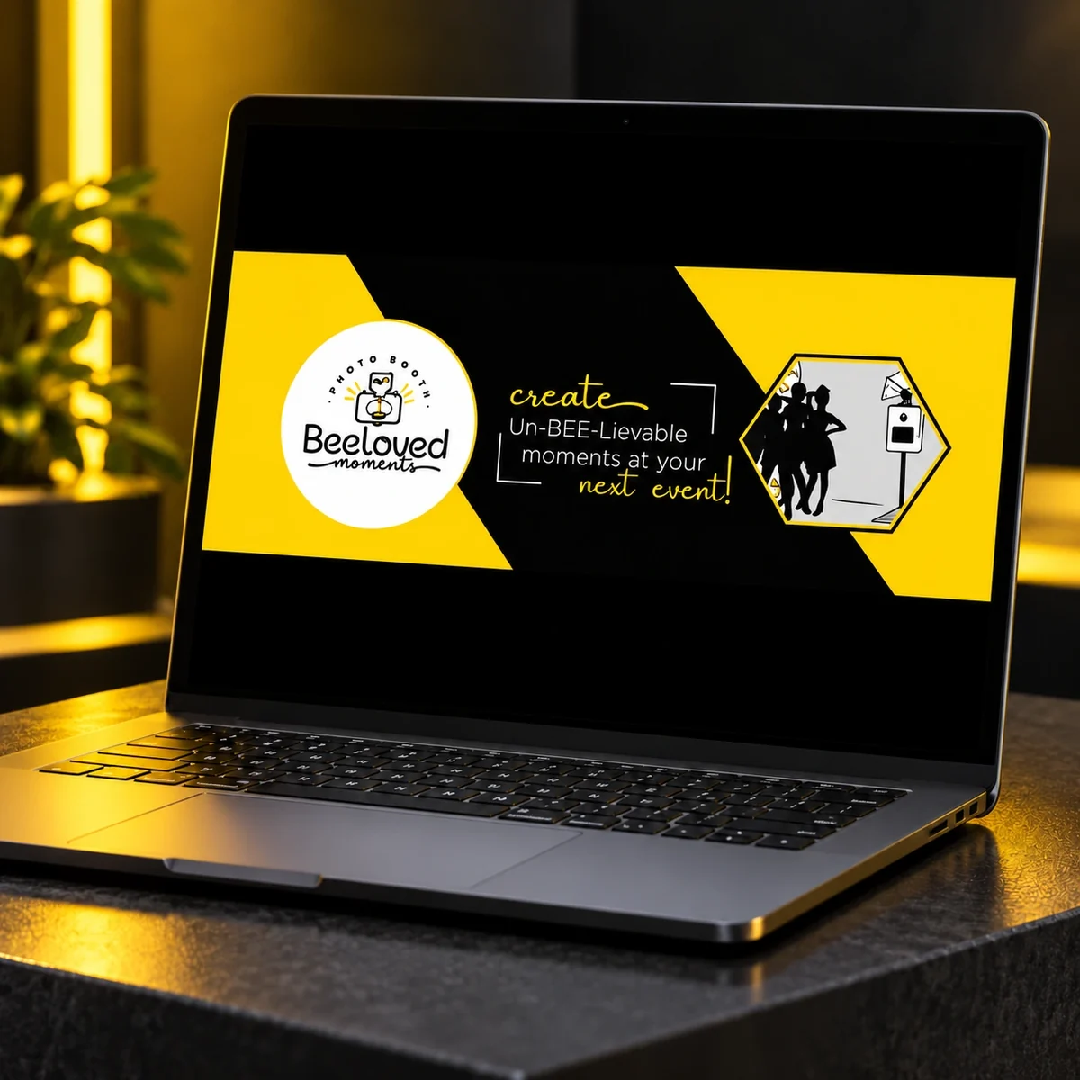 Yellow and black Beeloved banner design displayed on a laptop